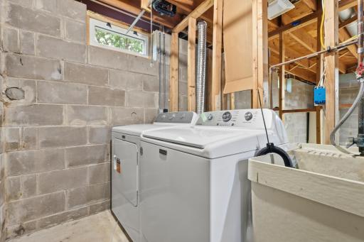 Lower level laundry room with utility sink.