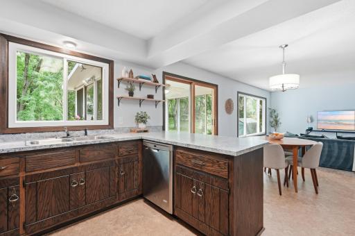 The kitchen provides a functional starting point with an open connection to the dining and living areas, while the sink overlooks the generous backyard and deck.