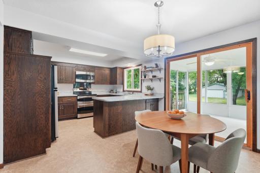 Dining area flows into the sunroom and continues outdoors to the deck and spacious backyard, creating a wonderful connection between the indoor and outdoor spaces.