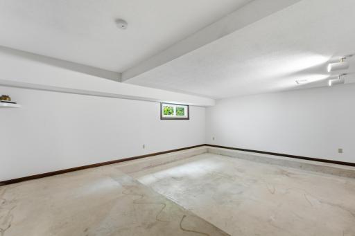 Step down into a spacious, sunken living room with a generous square layout that offers plenty of flexibility for furniture placement, gathering and entertaining.