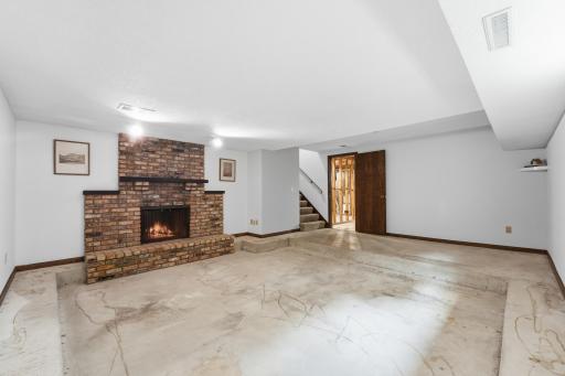 Bring your vision to the lower-level family room, with the space already in place and ready for carpet and your finishing touches. Note: seller has never used the fireplace. Virtually staged flame.