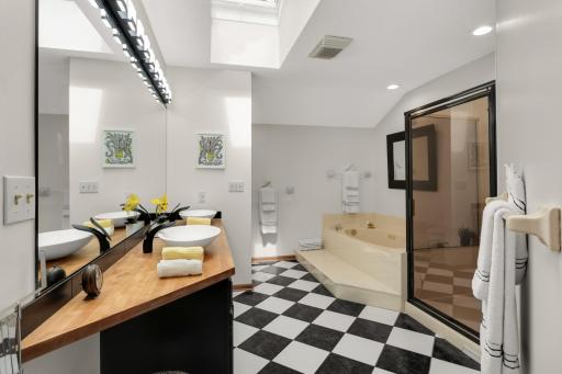 Primary bath has two sinks and separate jetted tub and shower
