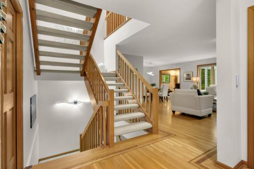 Stairway to upper bedrooms or down to family room and bar area