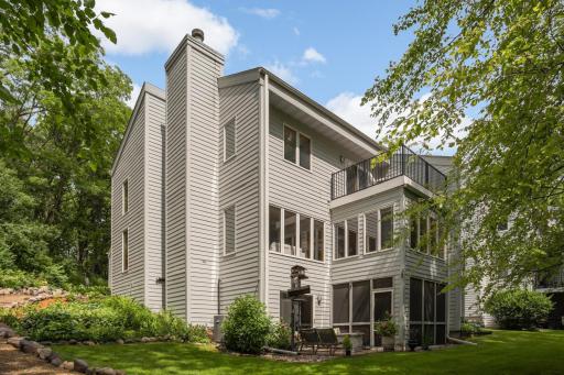 Three-level townhome surrounded by trees.