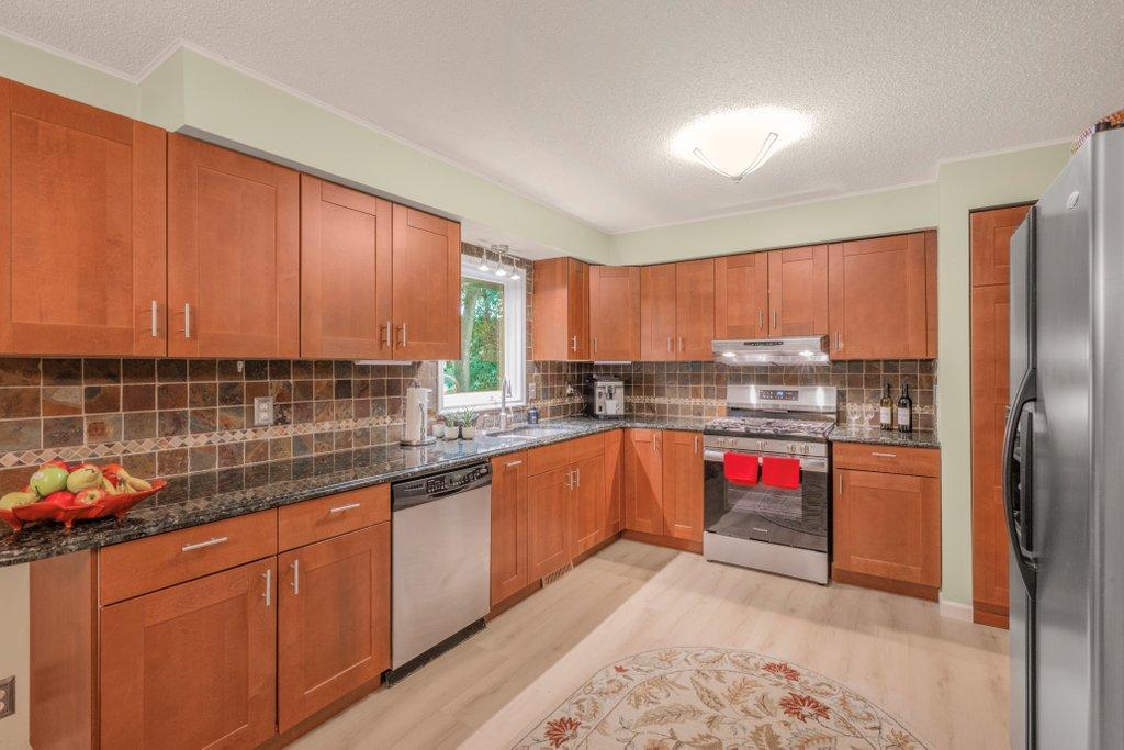 Updated kitchen with stainless steel appliances and granite countertops
