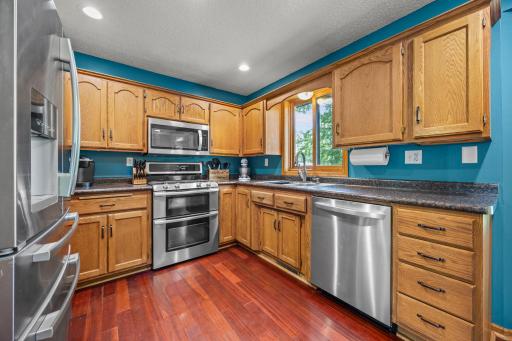 Functional kitchen featuring stainless steel appliances, warm wood cabinetry, with plenty of counter space for everyday living and entertaining.
