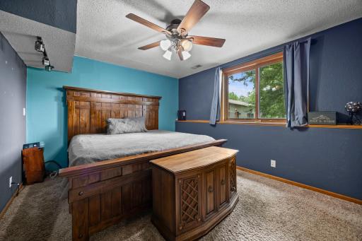Private lower-level primary bedroom offering added separation from the main living areas, with comfortable space and a relaxing atmosphere.