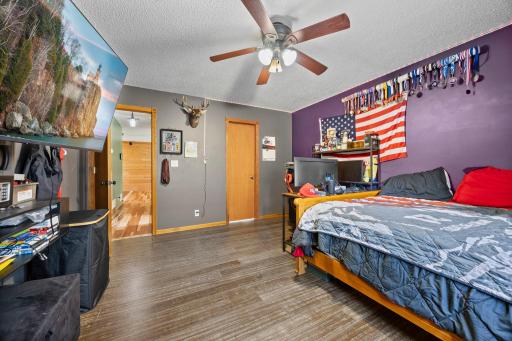 Spacious bedroom featuring a walk-in closet and convenient access to a pass-through bathroom, offering both comfort and functionality.