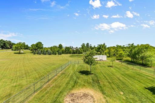 Pine trees planted along the back line allow for a driveway to an outbuilding