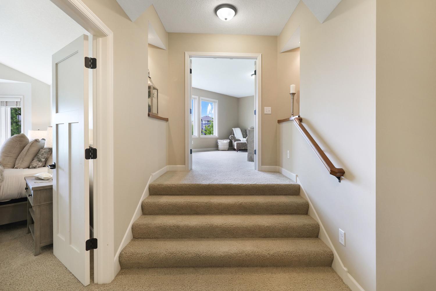 Upper-level landing provides access to the loft and spacious bedroom wing.