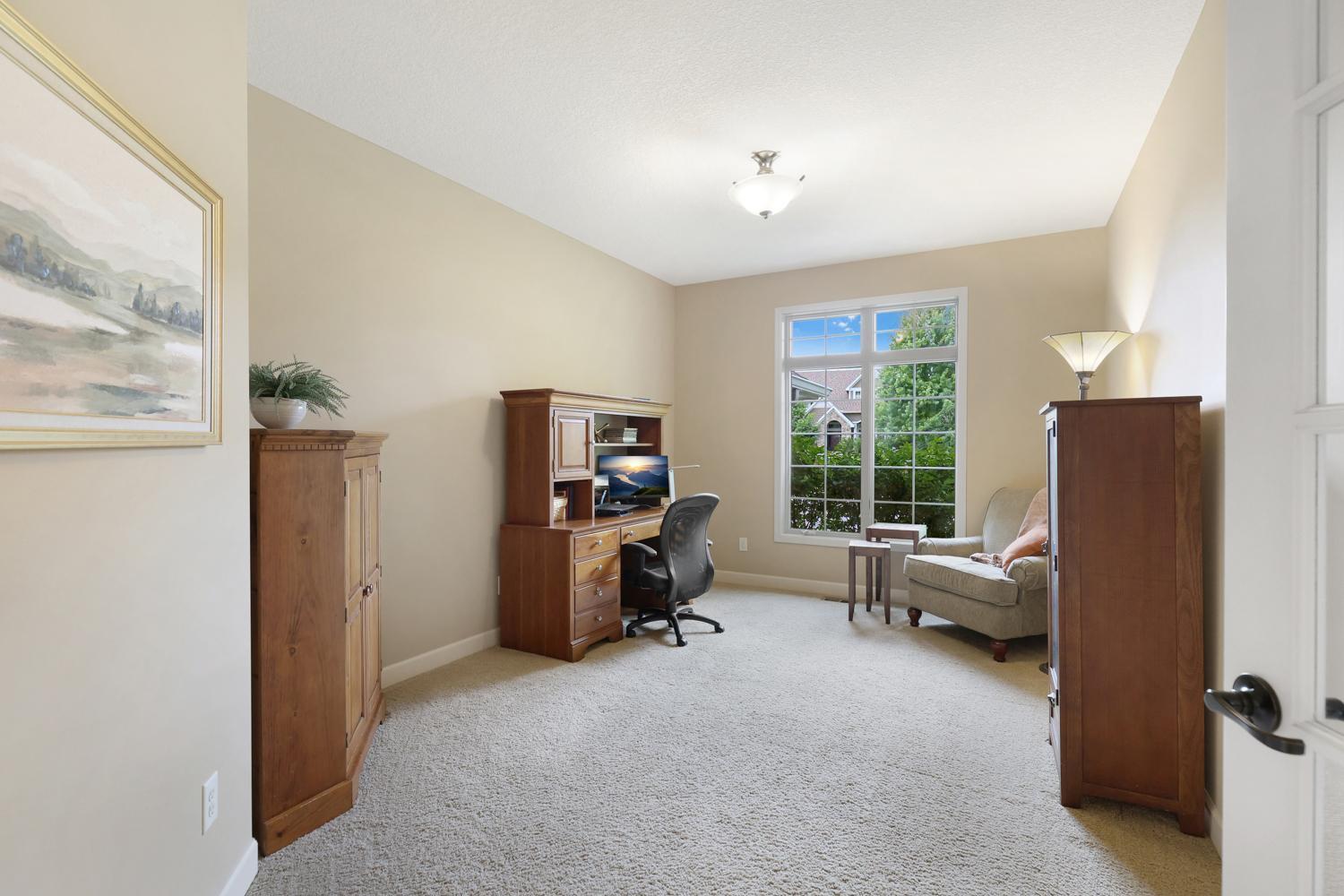 Spacious main-floor office featuring large windows, a quiet setting and flexible space for todays work-from-home lifestyle.