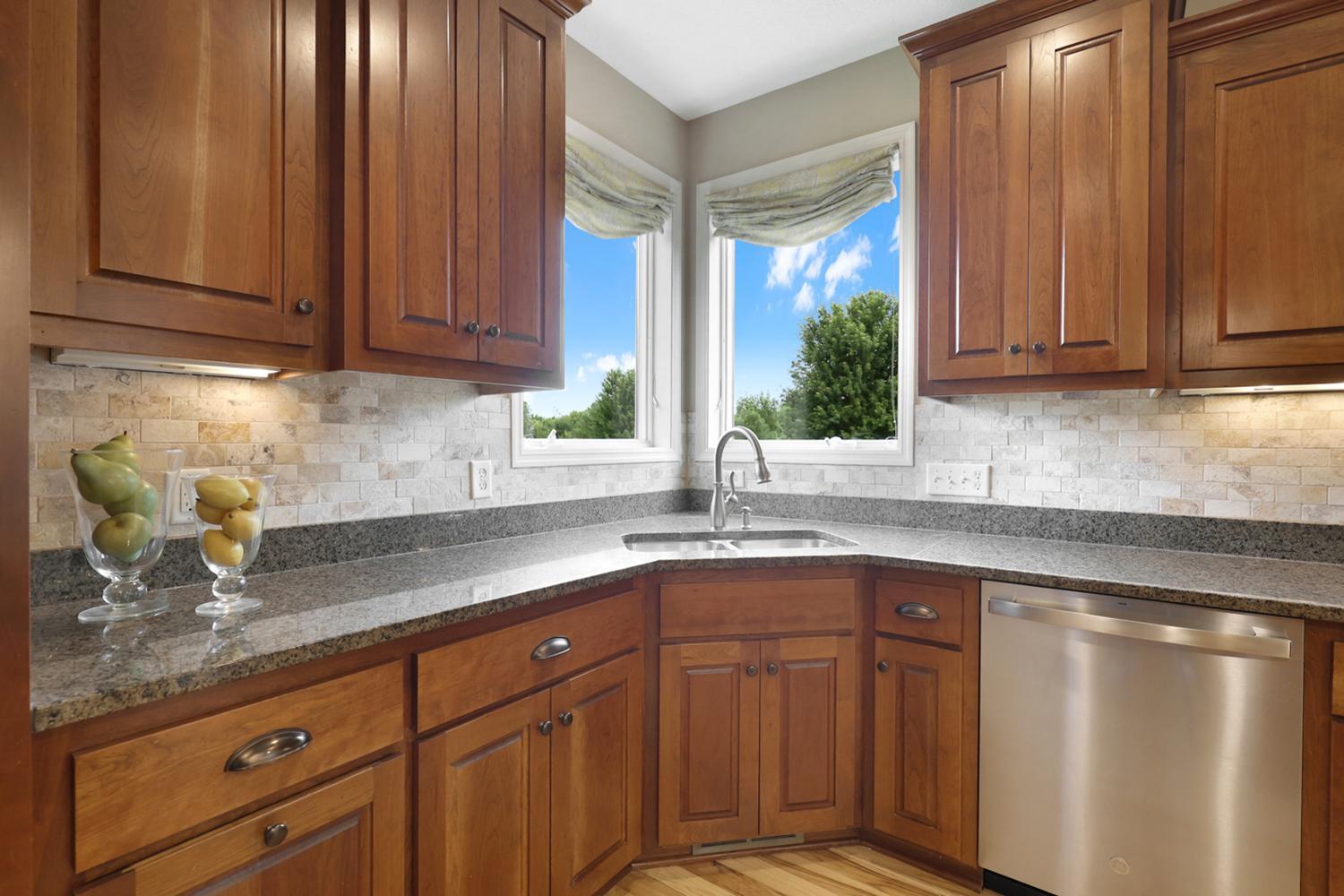 Corner kitchen sink with backyard views and abundant light.