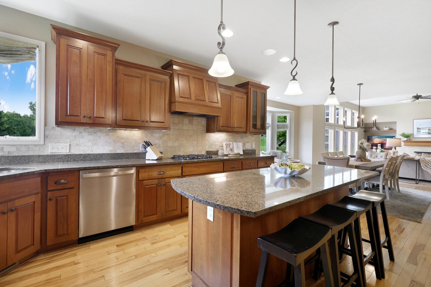 Oversized granite center island with breakfast bar seating.