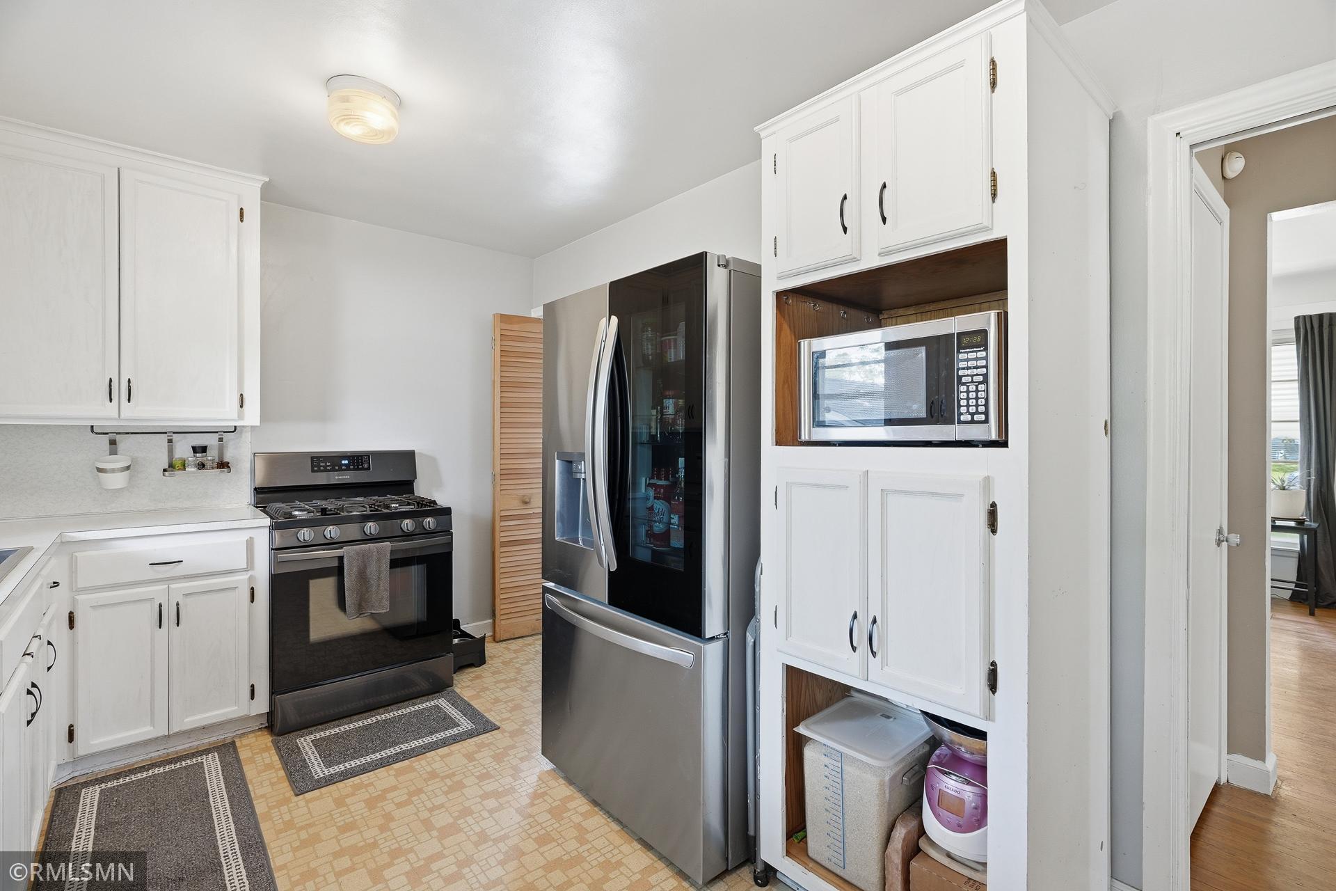 Equipped with stainless steel microwave, stove, and refrigerator.
