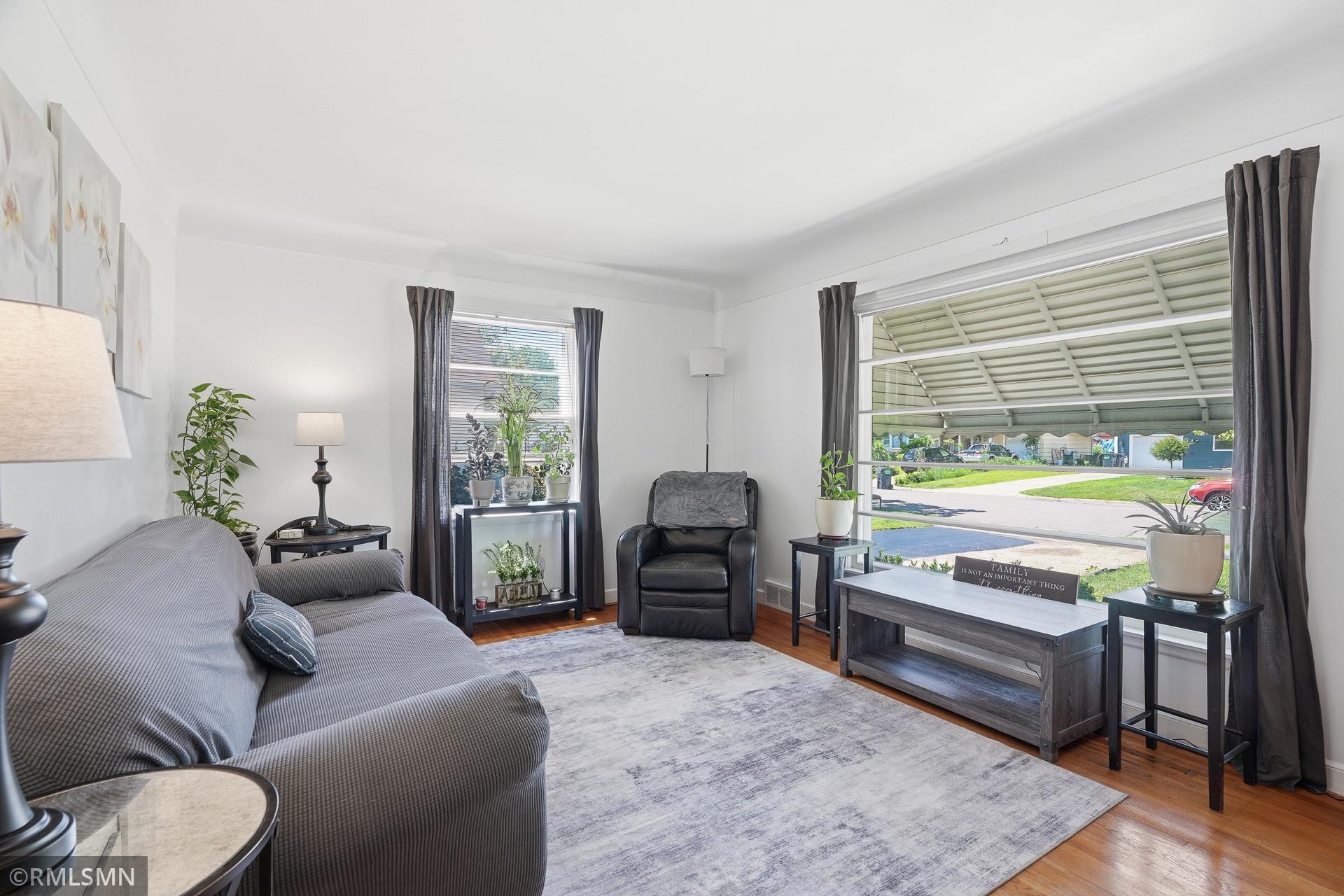 Big picture window and side window for natural light in the inviting living room.