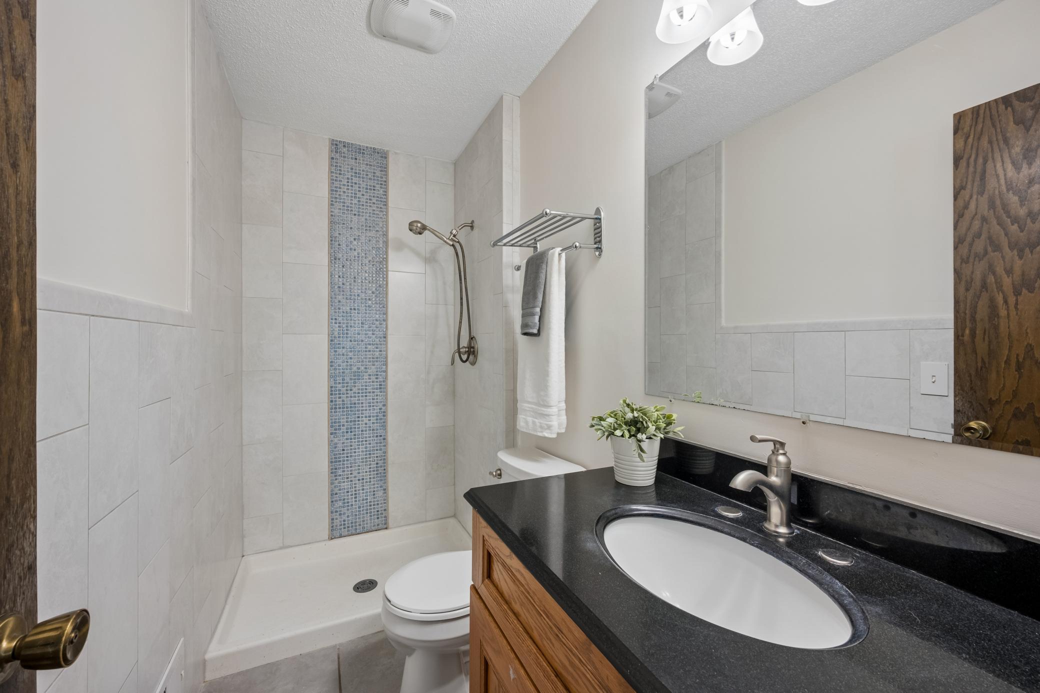 Primary 3/4 bath with a beautifully tiled walk-in shower.