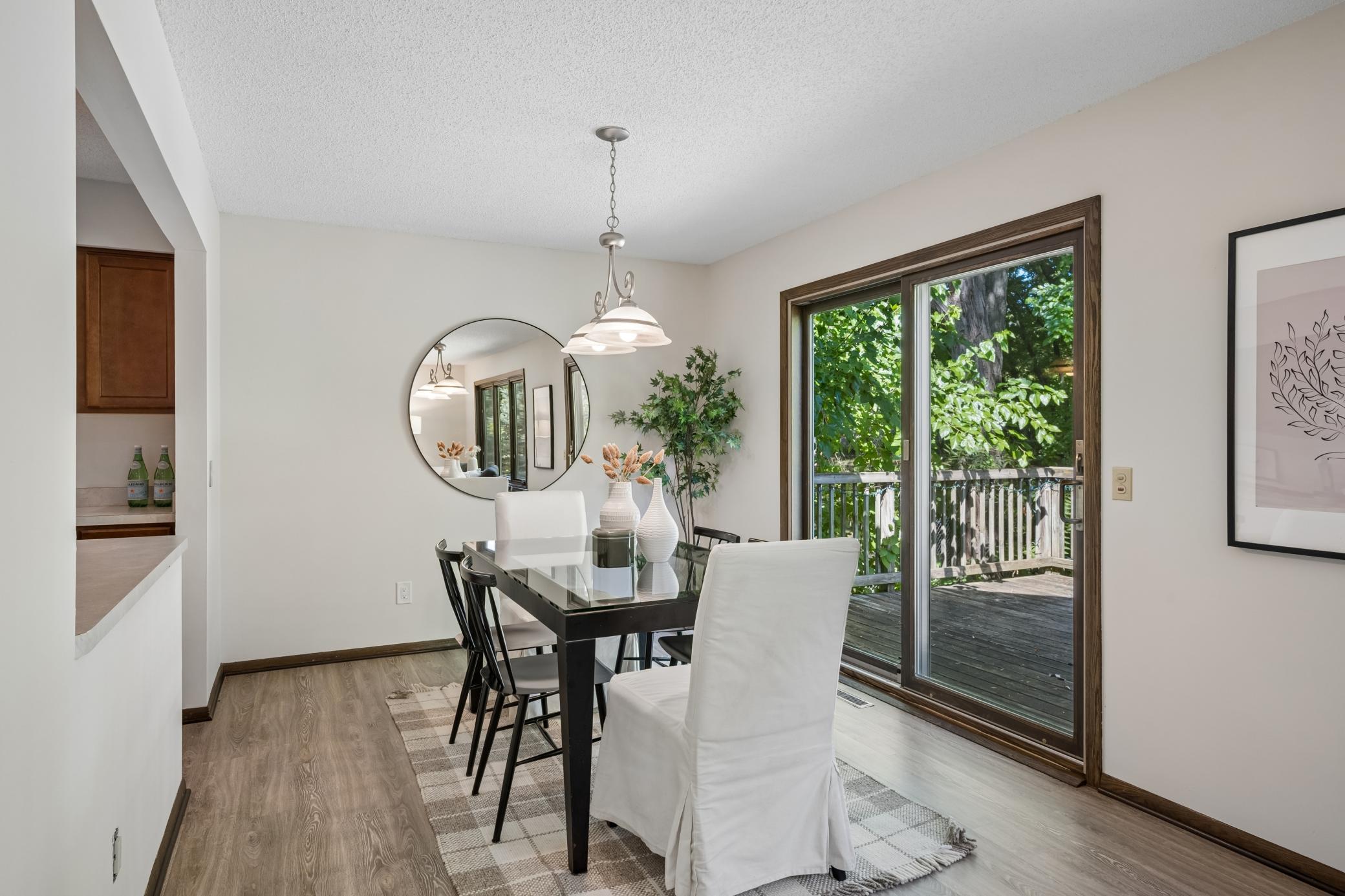The dining area opens to the deck, extending the living space outdoors