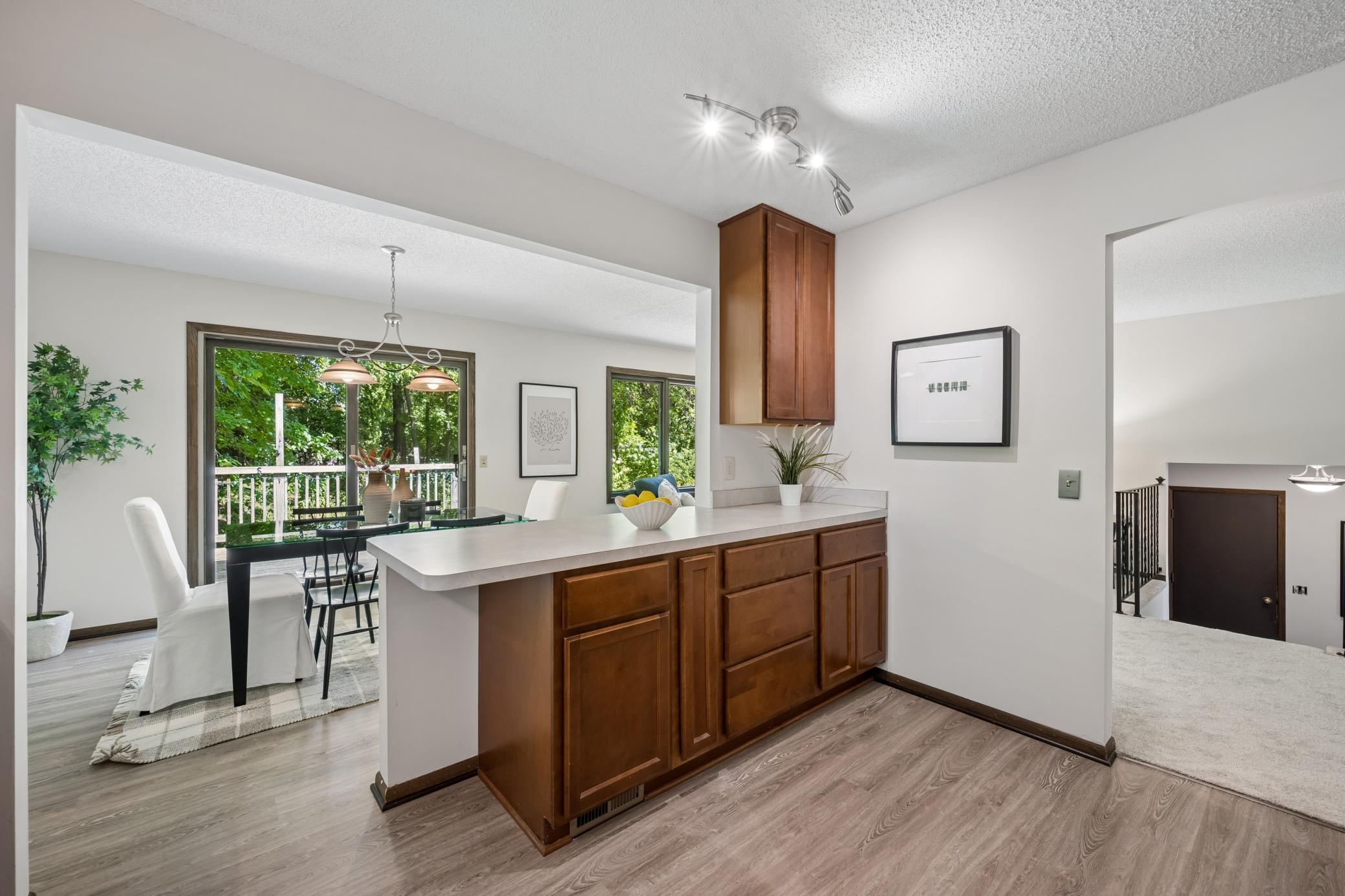 The open wall that connects the kitchen to the dining room, allowing natural light to flow between the spaces.