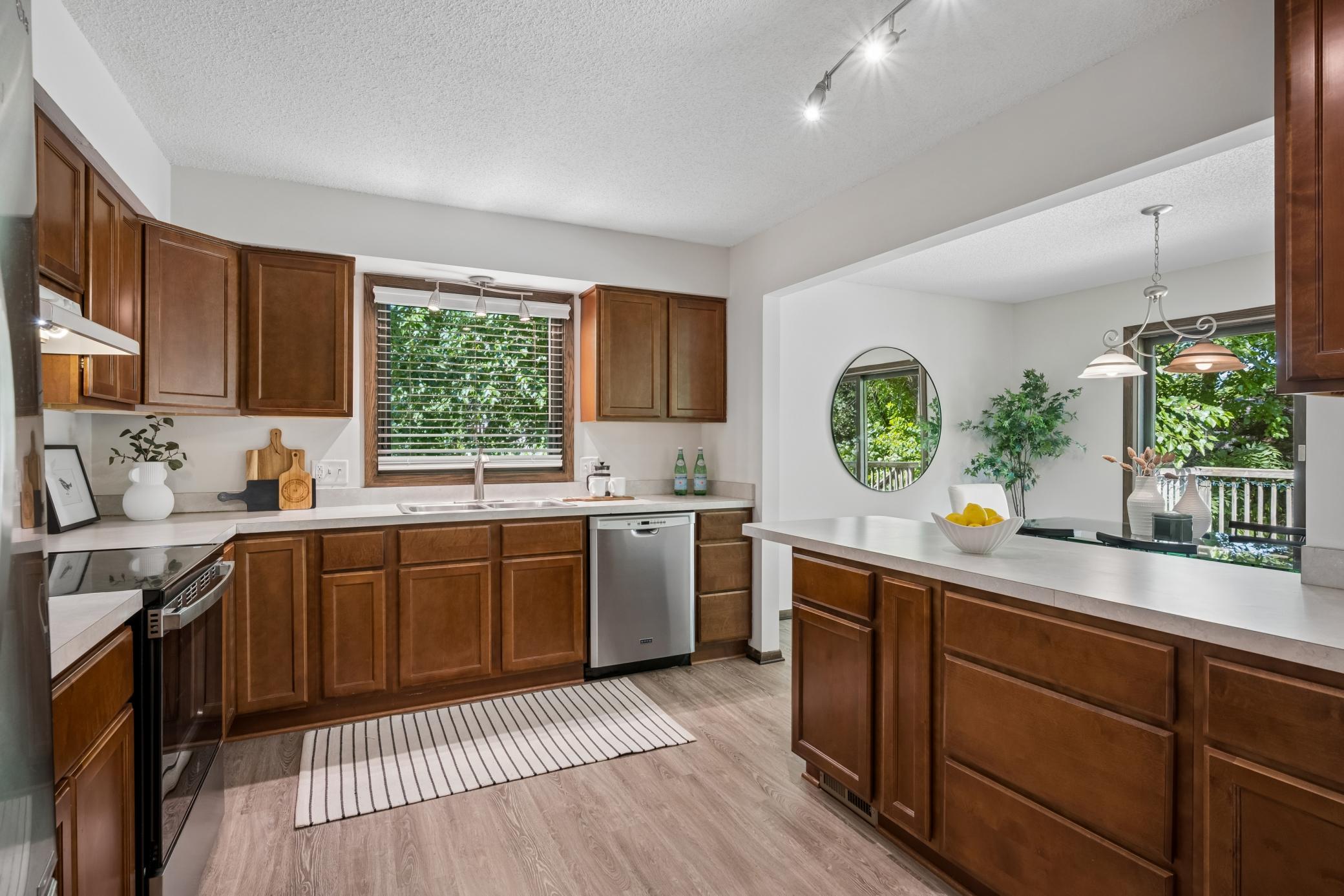 The spacious kitchen features stainless steel appliances, & generous cabinetry.
