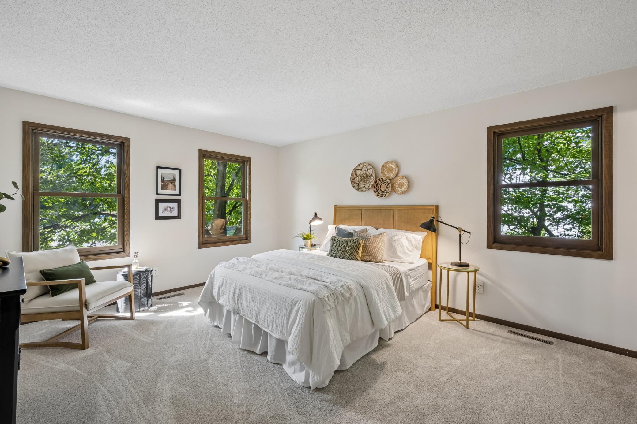 Spacious primary bedroom with room for a comfortable sitting area or additional furnishings.