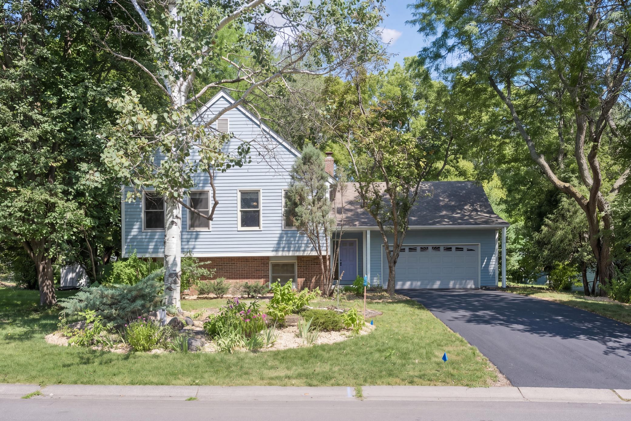 Surrounded by mature trees, this inviting home offers a fresh interior, comfortable living spaces, and room to make it your own.