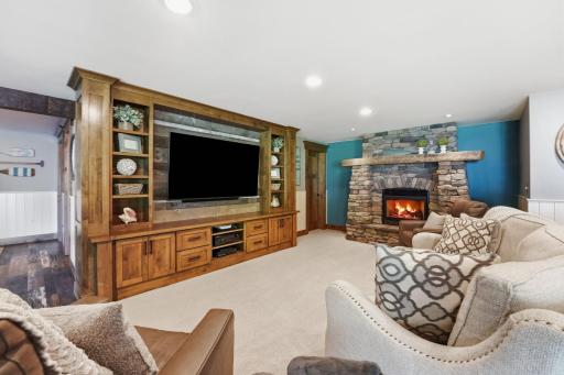 Lake inspired lower level is incredible with stone fireplace and built in media center.