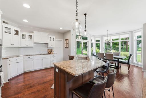 Gather around the heart of the home, appreciate contrast of stained and painted cabinetry.