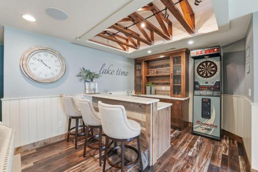 Designed with entertaining in mind, the wet bar creates a polished and inviting atmosphere.