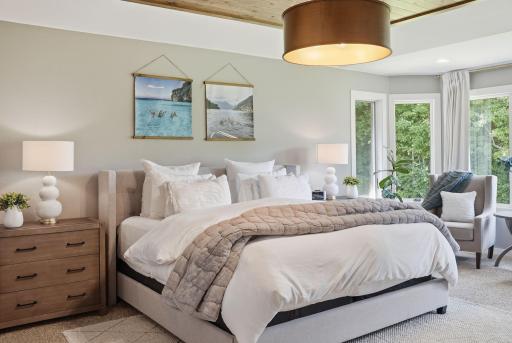 Trayed ceiling with wood clad ceiling perfectly adorned with drum light fixture.