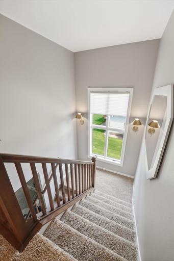 Tremendous natural light enters the main stairwell. Details never missed, the sconces here are perfect low light selection.