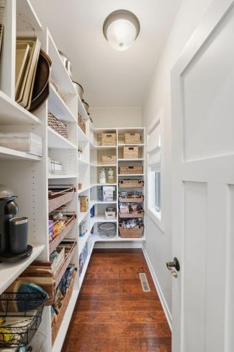 Walk-in pantry features abundant storage for groceries, small appliances, and meal prep essentials. Window for natural light also overlooks the back deck.