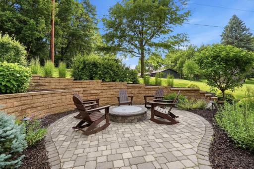 Professional landscape includes pavers, and retaining walls and great selection of yard enhancing plants.