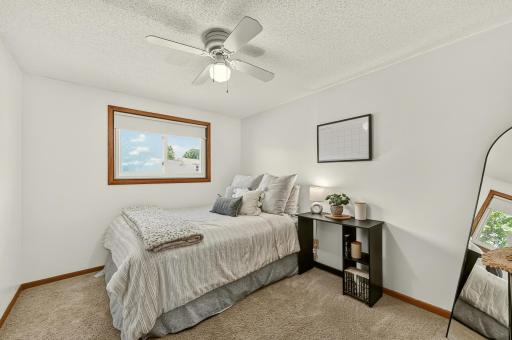 Bedroom two on main floor with ceiling fan