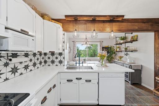 Stylish tile backsplash adds character and visual appeal to the kitchen.