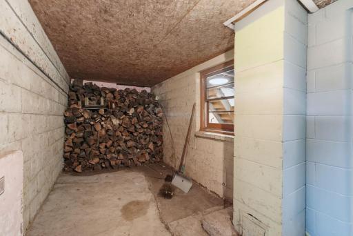 Dedicated wood room provides convenient storage for firewood and outdoor supplies.