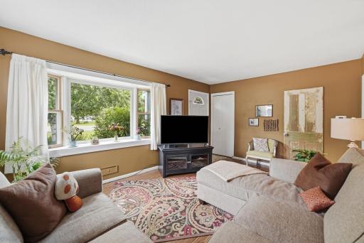 Large bay window creates a cozy nook while bringing the outdoors inside.