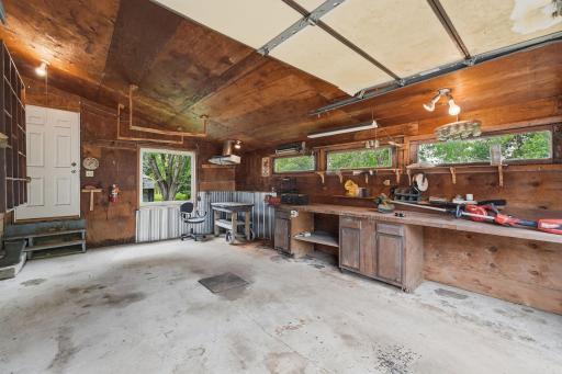 Workshop has great light and back yard views. Combines vehicle storage with a practical workshop space.