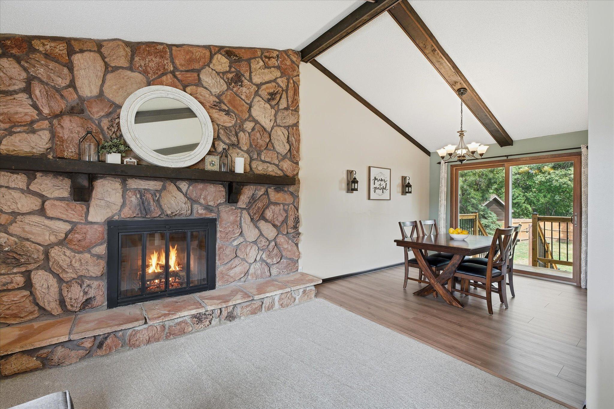 Large wood burning stone fireplace in living room