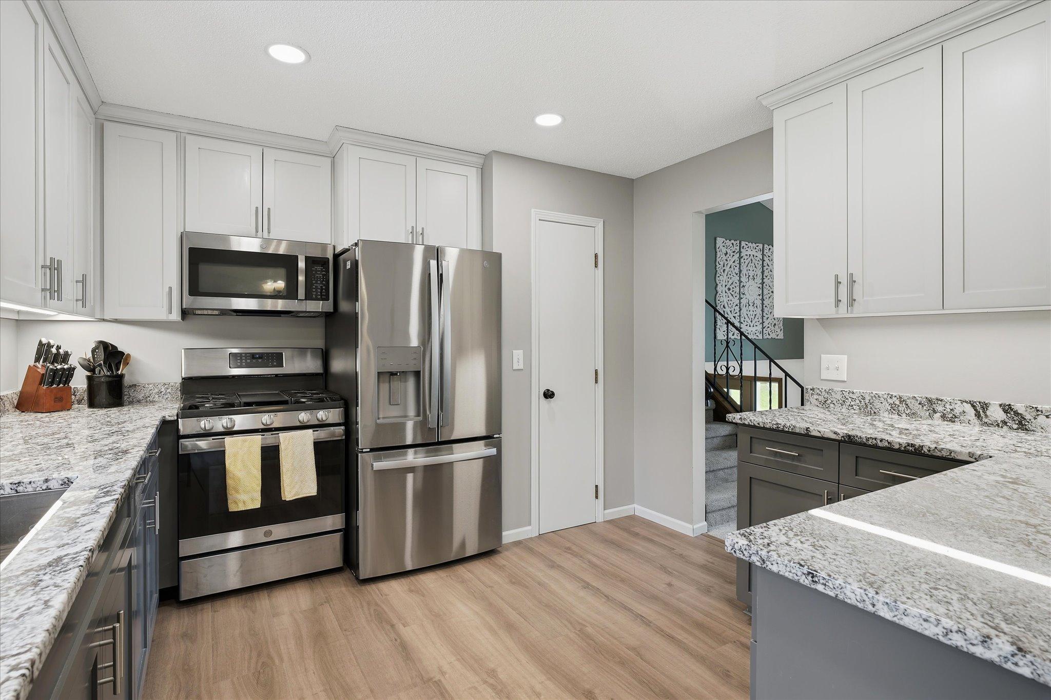 Fully updated kitchen with stainless steel appliances, granite counters, and custom cabinets