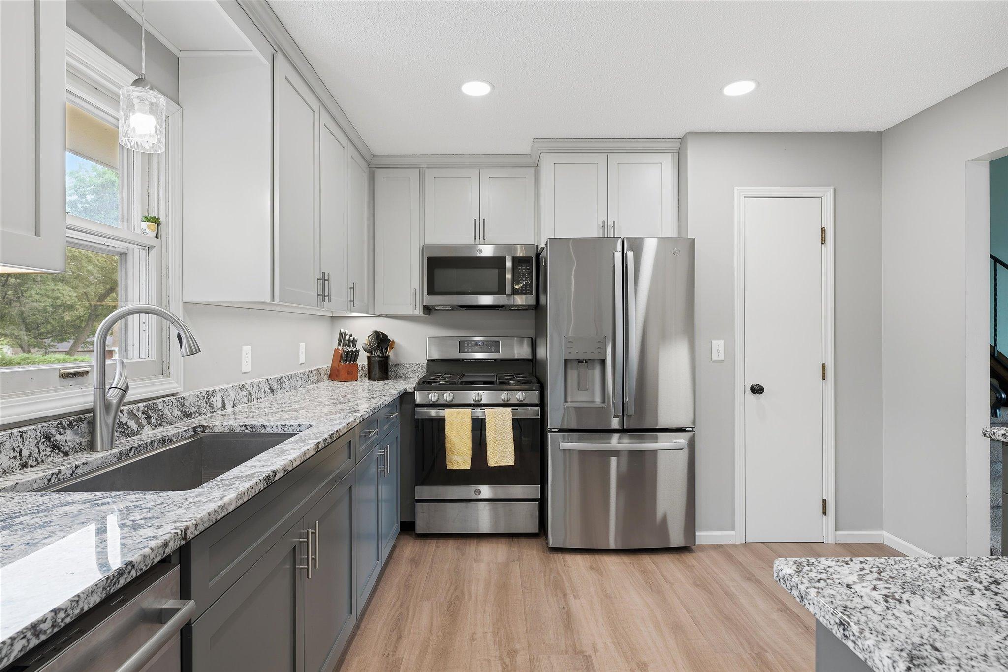 Fully updated kitchen with stainless steel appliances, granite counters, and custom cabinets