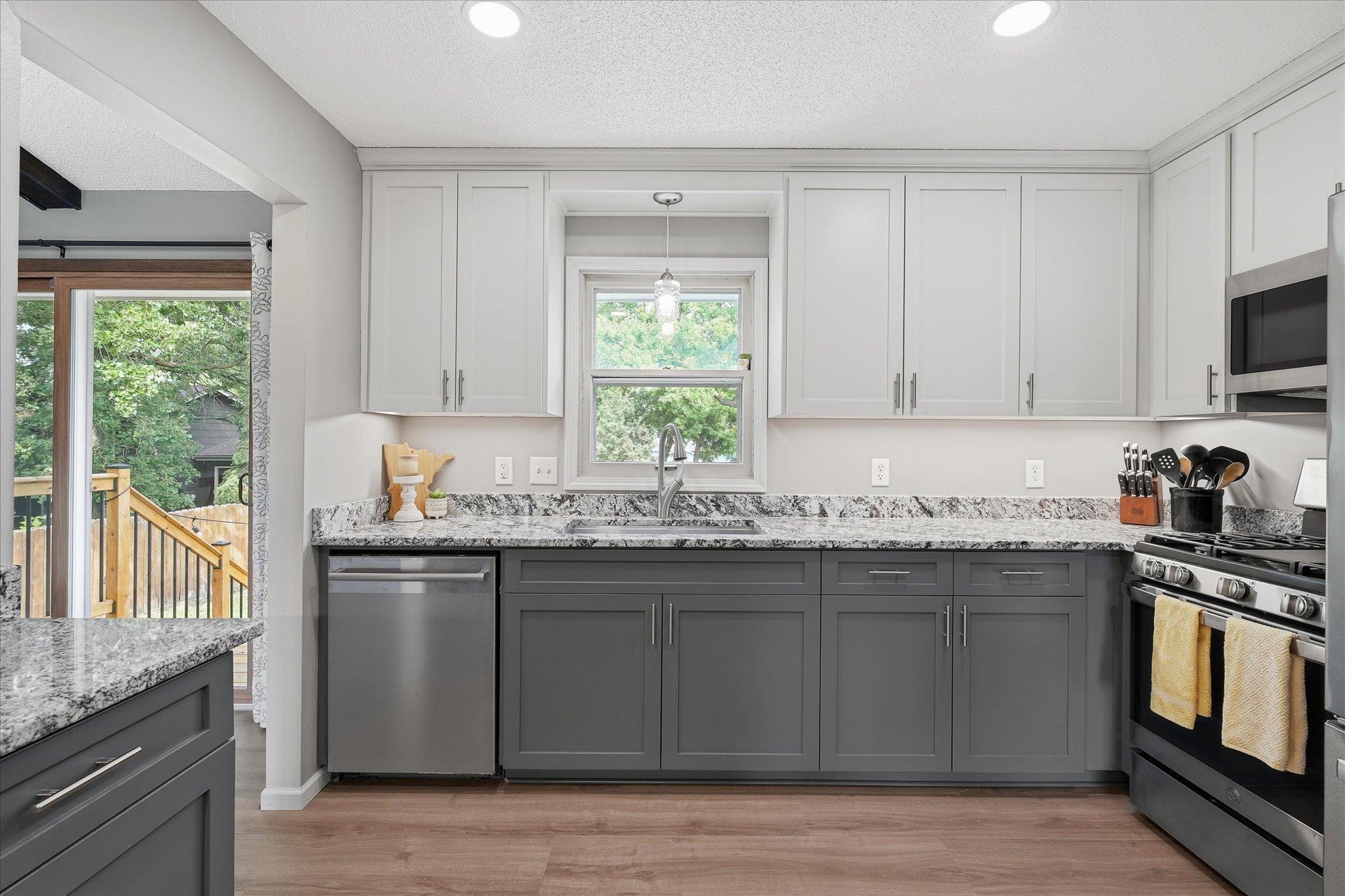 Fully updated kitchen with stainless steel appliances, granite counters, and custom cabinets