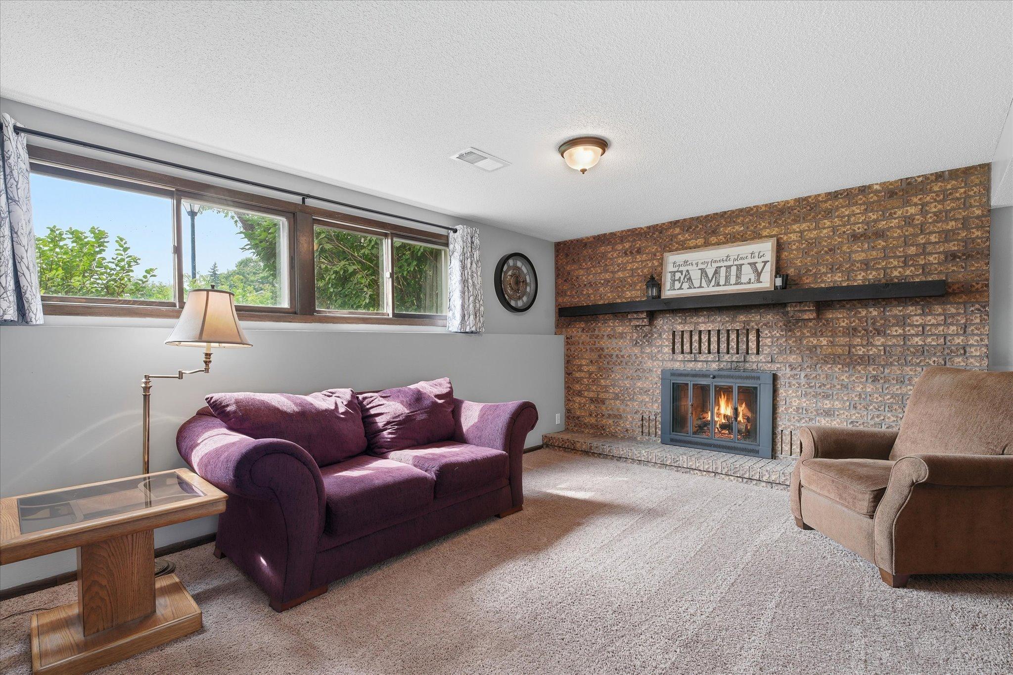 Lower level family room with wood burning fireplace