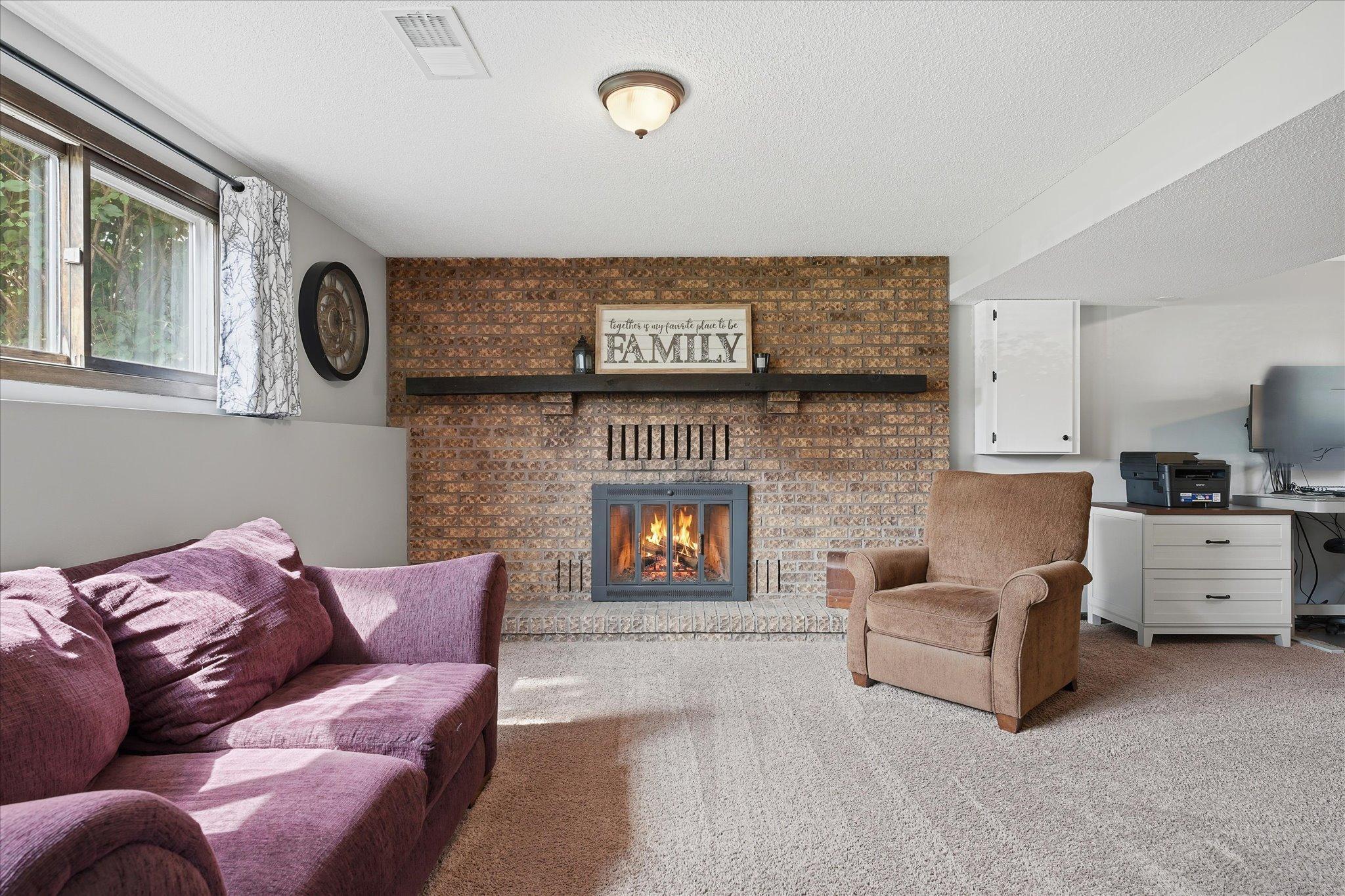 Lower level family room with wood burning fireplace