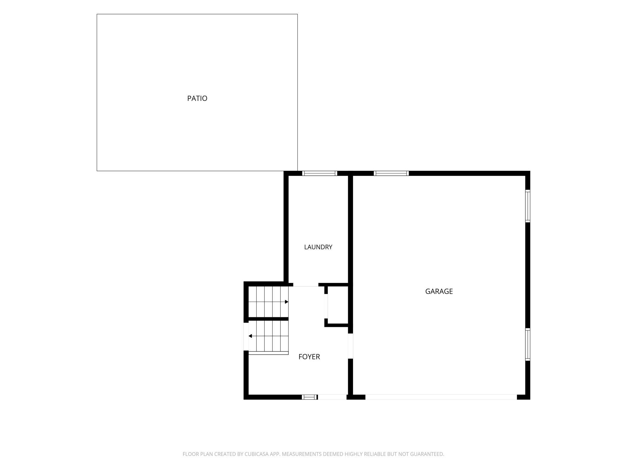 Ground level foyer, garage, and patio