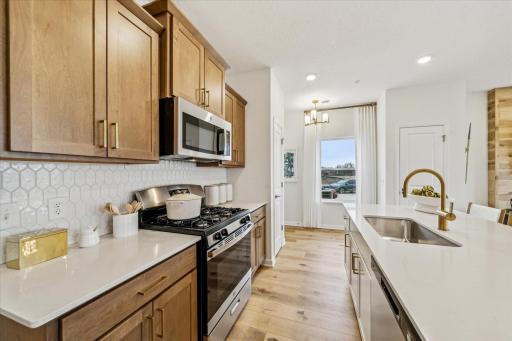 Cook up something special in this bright kitchen featuring a spacious island and stylish finishes. *Photo of a previously built home of the same floor plan. Finishes/options may vary.