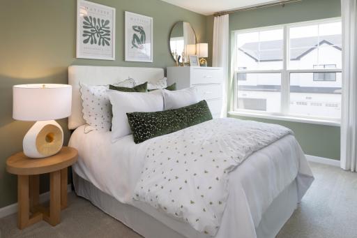 A secondary bedroom ready for your personal touch, with a large window and room for your favorite furnishings. *Photo of a previously built home of the same floor plan. Finishes/options may vary.