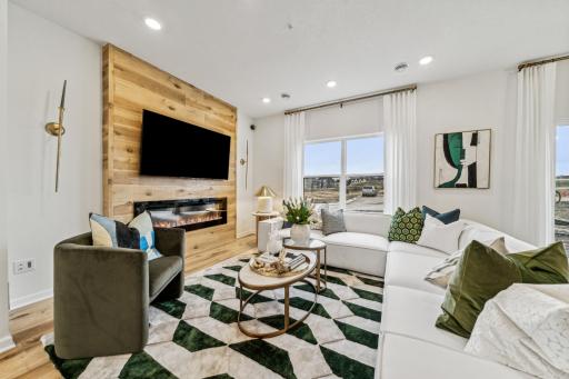 Kick back and relax in this inviting living room, featuring a stunning fireplace and plenty of natural light. *Photo of a previously built home of the same floor plan. Finishes/options may vary.
