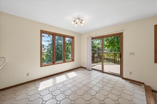 Tile floors, oversized windows and patio walk out to an entertaining size deck.