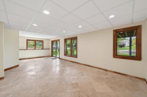 Travertine tile in the family rooms makes for easy cleanup with indoor/outdoor activities.