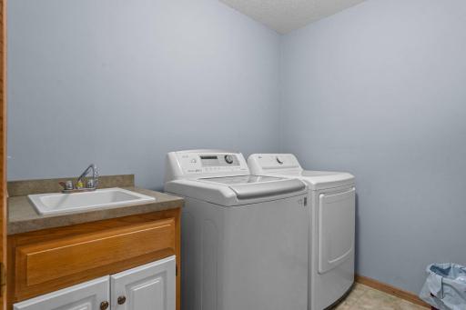 Main level laundry room complete with a sink